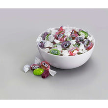 Assorted zero sugar hard candies in wrappers in a white bowl