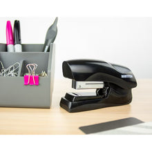 Bostitch manual stapler on desk, black body with chrome staple channel