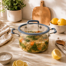 Blue borosilicate glass stock pot with lid, filled with food