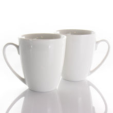 White porcelain mugs with curved handles, glossy finish, two-mug close view