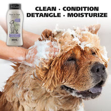 Wahl 4-in-1 dog shampoo and conditioner bottle beside foamy lather on dog fur