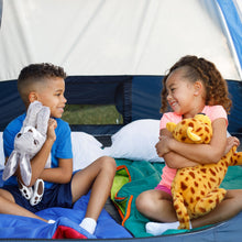 Youth sleeping bag in blue with green interior panel, children holding plush toys