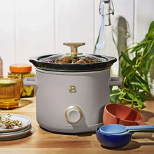 Porcini taupe manual slow cooker with lid, knob control and handles.