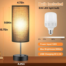 Table lamp with cylindrical fabric shade and included E26 LED bulb, with charging specs.