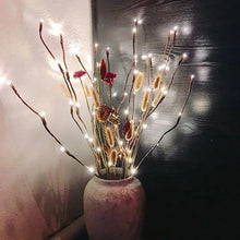 Warm white LED-lit branch twigs in a textured ceramic vase