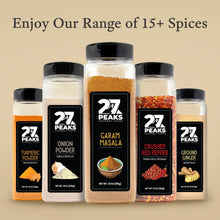 Garam masala bottle among assorted spice jars with black caps