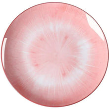 Pink and white dinner plate with radial swirl pattern
