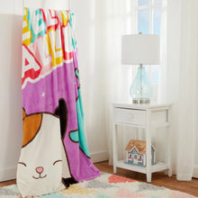 Purple kids fleece blanket draped over bed with fox and cat character print