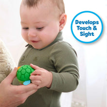 Child holding a green textured sensory ball with red accents