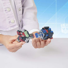 Action figure 5-pack robots, blue, green, and red figures held in hands