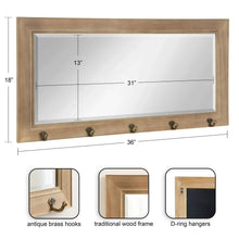 Rectangular wall mirror with wood frame and five metal hooks along the lower rail