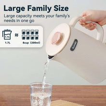 Cream electric kettle pouring water into a glass on a table