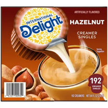 Front of hazelnut coffee creamer singles box with 192 count and creamer cup