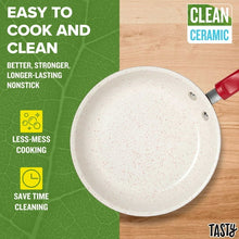 Speckled white interior of red ceramic non-stick frying pan with red handle