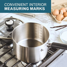 Stainless steel saucepan with interior measuring marks and black lid knob