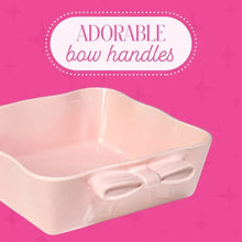 Pink ceramic square baking dish with bow handles, close view