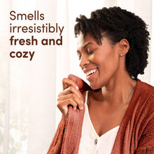 Downy Cozy Chai Latte scent lifestyle scene, woman holding knit fabric close