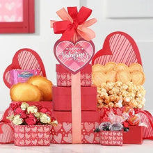 Valentine gift tower with heart sign, red and pink boxes, ribbon and treats