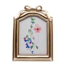 Gold bow resin tabletop picture frame with floral insert, 5x7