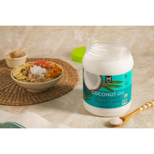 Coconut oil jar on countertop with wooden spoon and bowl nearby