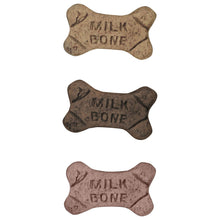 Three bone-shaped dog biscuits with stamped 'Milk Bone' text