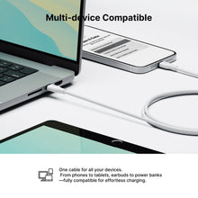 White Lightning charging cable connected to laptop and phone