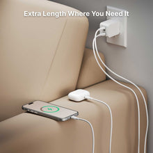 White USB-C charging cable connecting power adapter to smartphone, flexible silicone design