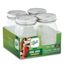 Clear glass mini mason jars with silver lids in a green-labeled 4-pack carton