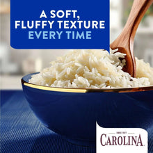 Blue bowl of fluffy white rice with a wooden serving spoon