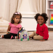 Wooden take-along dollhouse toy with two children sitting beside it