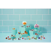 Mini fridge playset with shelves filled with miniature groceries and bottles