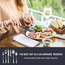 Stainless steel silverware set: person holding knife and fork by a plated meal