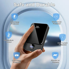 Black magnetic wireless power bank held up with charging status indicator