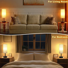 Table lamp pair with warm linen drum shades and black bases on side tables