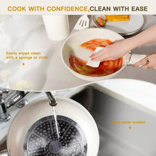Cream white nonstick pot being rinsed under running water at the sink