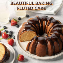 Fluted bundt cake pan with a molded cake on a plate.