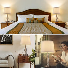 Pair of bedside table lamps with white linen shades and metal bases