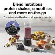 Portable personal blender on countertop with clear jar, black base, and blade assembly