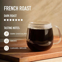 Glass mug of dark roast coffee with crema