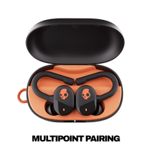 True wireless earbuds with open charging case, black earbuds and orange inner tray.