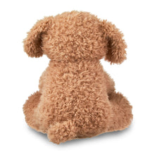 Brown plush puppy toy with green bow tie, sitting pose, side view