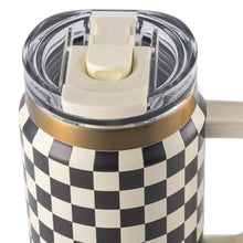 Top view of clear dual-straw lid with beige straw pieces on a cream-and-black check tumbler