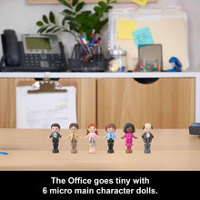 Mini office character dolls standing on a tabletop
