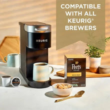 Keurig-compatible coffee pods display with pod box and cups