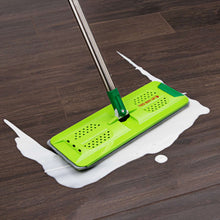 Flat mop with bright green microfiber pad on dark wood floor