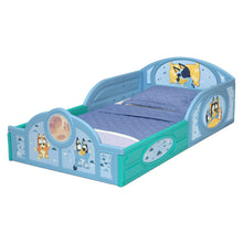 Toddler bed with guardrails, blue frame with character side art and blue quilted bedding