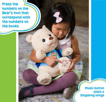 Plush storytelling bear toy with numbered button on foot hugged by a child