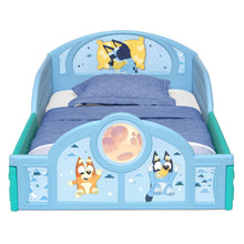 Toddler bed with guardrails, front oval character window and blue bedding on the frame