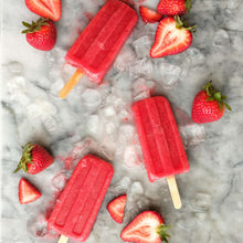 Strawberry extract box artwork with pink popsicles and sliced strawberries