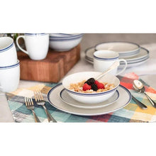 White ceramic bowl with blue rim on matching plate, with blue-trim mugs